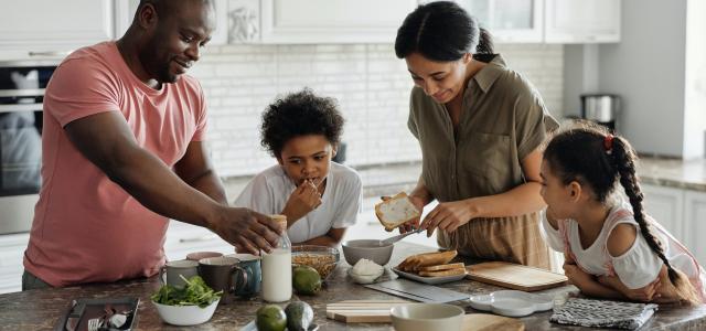 Family with two children making breakfast