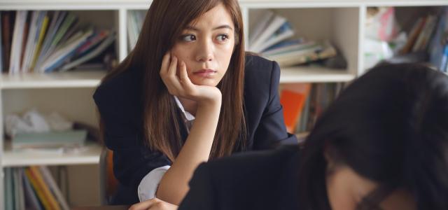 Bored-looking girl sitting in a classroom