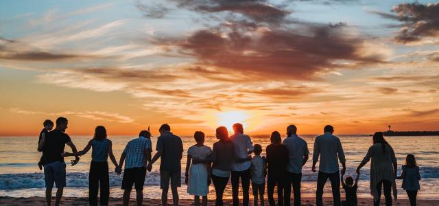 people standing on shore during golden hour by Tyler Nix courtesy of Unsplash.